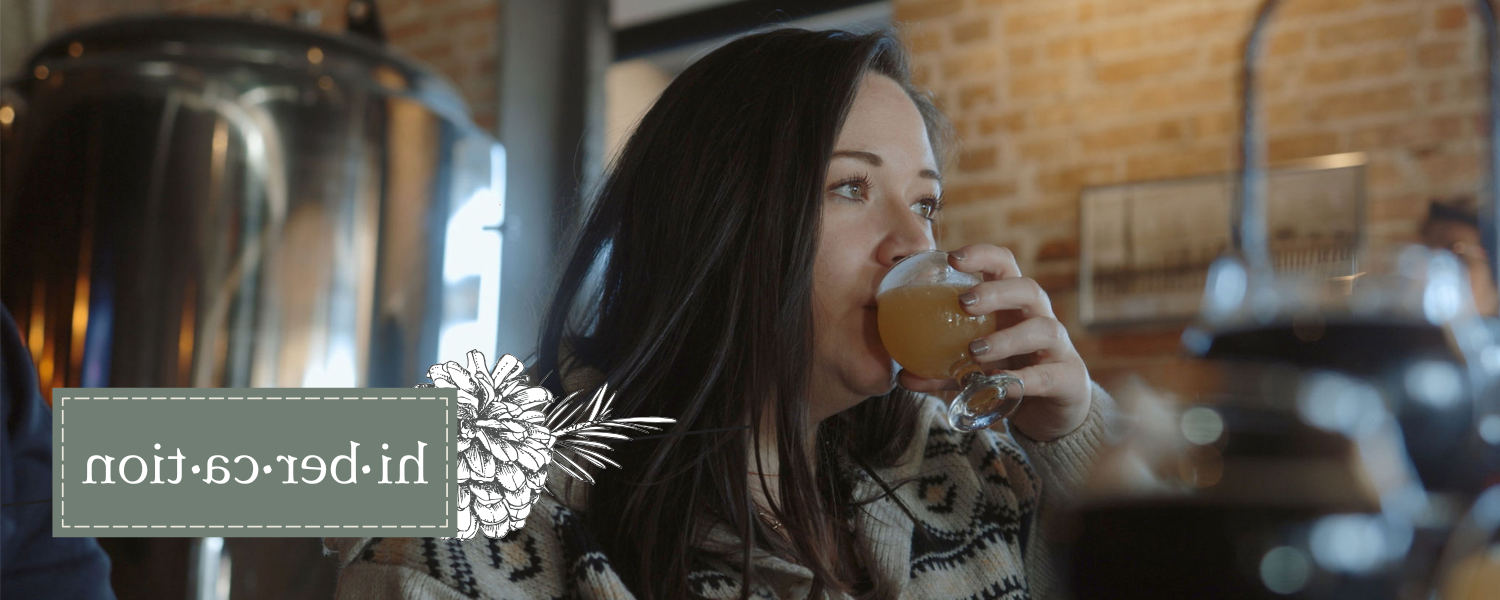 Women drinking a glass of  a specialty Hibercation brew